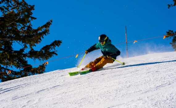 A skier carves a turn on a groomed run at Deer Valley, Park City, UT