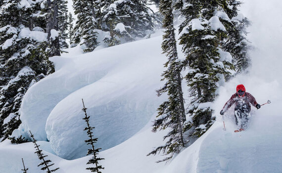 A skier sends a steep line through powder pillows. Image courtesy of Atomic.