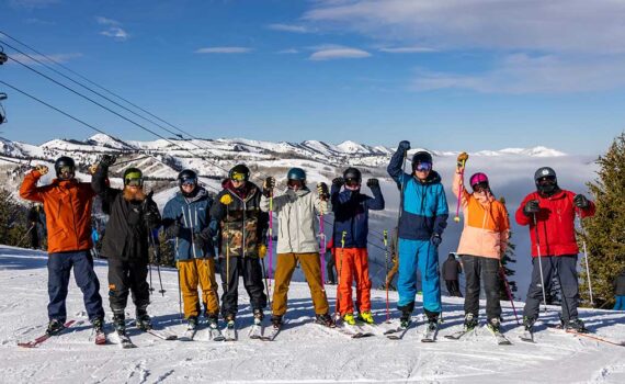 Jans Expters take a group phto together with arms raised while ski testing at Deer Valley Resort, Park City, UT