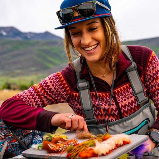 Jans Expert examines her tackle box in the bed of a pickup.