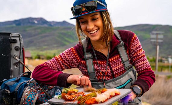 Jans Expert examines her tackle box in the bed of a pickup.