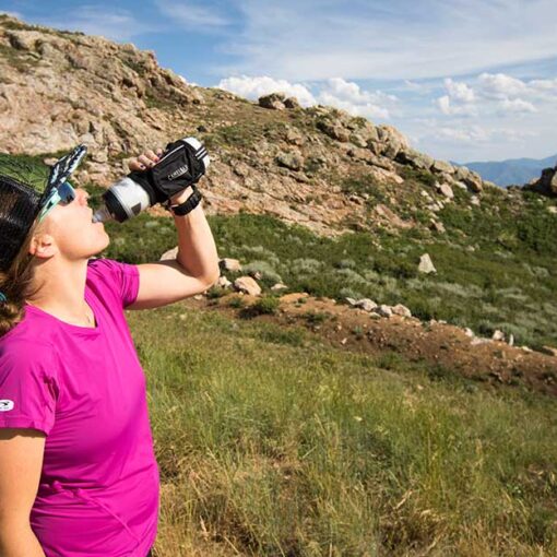 Jans Expert breaks for some quick hydration while on a trail run in the Wasatch Mountains