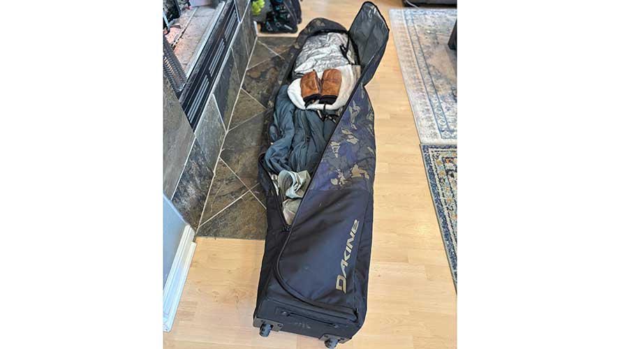 Dakine's Fall Roller Bag is packed with skis, boots and ski clothing for added cushion on top.