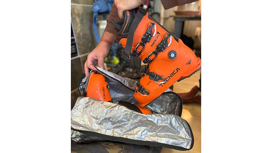 Jans Expert places ski boots in a boot Dakine boot bag.