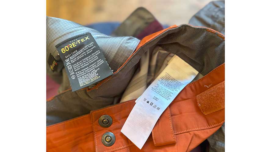 IMG_8113_888x500 Close up shows care instructions written on a garment tag for gore-tex outerwear.