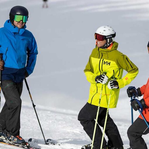 Jans Experts in brightly colored ski jackets laugh with one another at Deer Valley Resort.