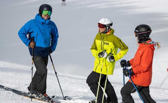 Jans Experts in brightly colored ski jackets laugh with one another at Deer Valley Resort.