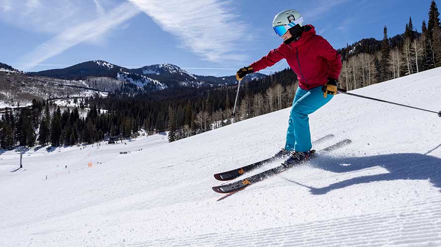An intermediate level practicing carving turns on high performance skis at Solitude Resort. 